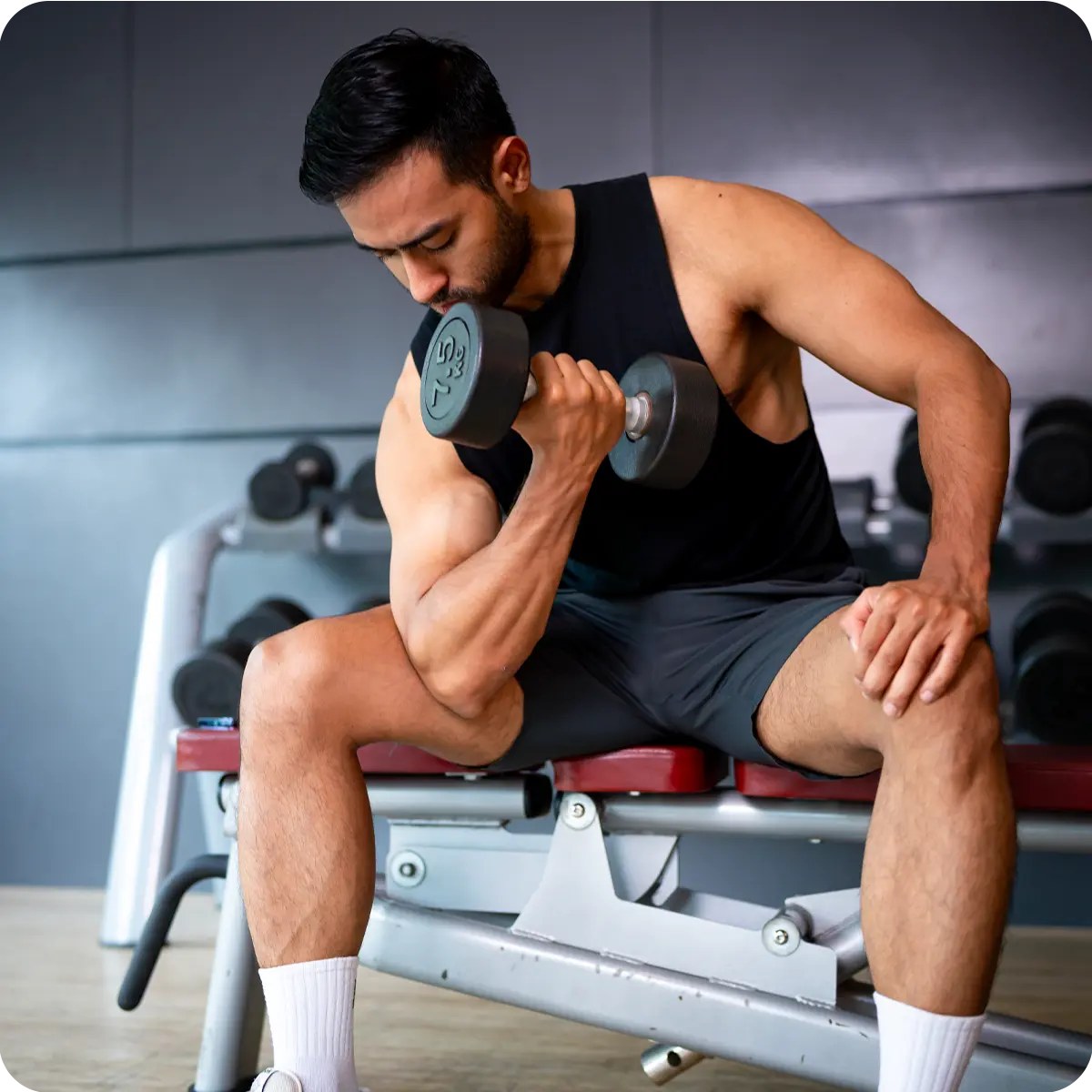 Photo of an athletic man performing weight training in a gym (bicep curl), representing muscle support, strength, and recovery aided by Inlife Magnesium Glycinate.
