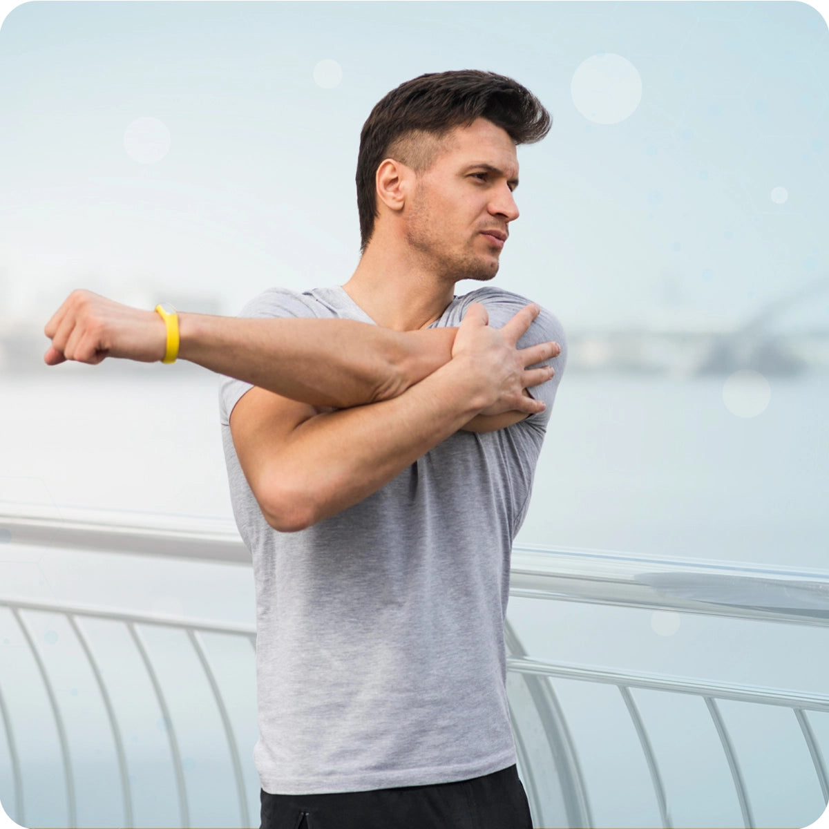 Key benefit of inlife Magnesium complex Photo of a man in workout gear stretching his shoulder outdoors, illustrating muscle function and post-exercise recovery