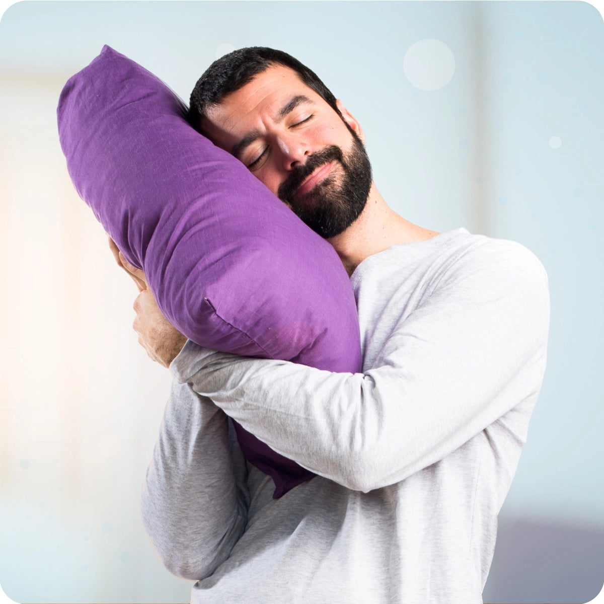 Key benefits of magnesium complex  a man with a beard peacefully hugging a large purple pillow, representing relaxation and quality sleep support